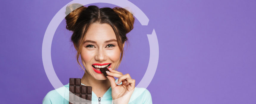 woman eating a bar of chocolate